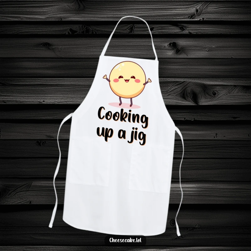 Funny apron showing a wobbly cheesecake round with stick legs doing a silly dance jig, perfect for the fun-loving baker.