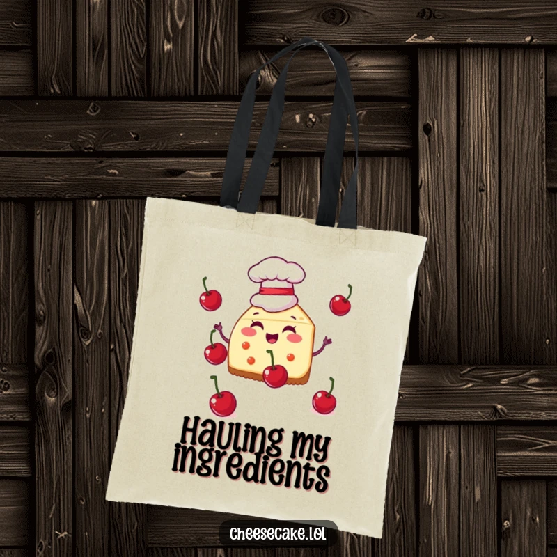 Funny tote bag showcasing a cheesecake slice in a chef hat juggling cherries, perfect for carrying kitchen essentials with flair.